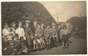 The Seat at Donaldsons Lodge about 1950.
From Left to right  Jean Mitchell,Small Child ? Betty Mitchell, Florence Fulton, George Swan (Dod) Jake Fulton (Blode) Harry Swan,Tom Swan (Sen) Fred Mitchell, Jimmy Miller, Olive Swan, Front Jim Miller, James Swan (Edinburgh) Allan Mitchell, Dog, Joe Moffat, Thomas Swan (Edinburgh), Nicol Swan, Rita ?, Richard Mitchell, Margaret Swan (Edinburgh) Sheena Swan.